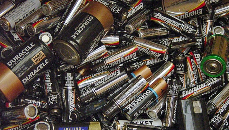 Is it safe to throw used batteries in the trash?