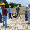 Farris Leonard (second from right) speaks with an electrical lineworker class at James Sprunt Community College.