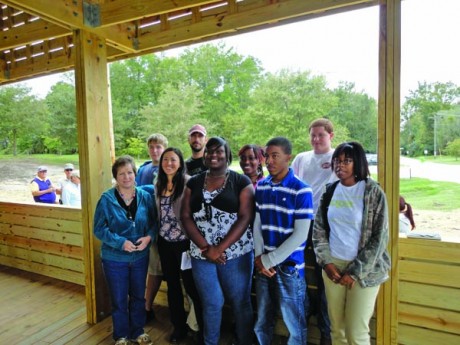 Teachers Emily Pilloton (second from left, front row) and her partner Matt Miller (second from left, back row) with their Studio H students at Bertie High School, showing off the Windsor Super Market building they designed and built in 2011. Studio H