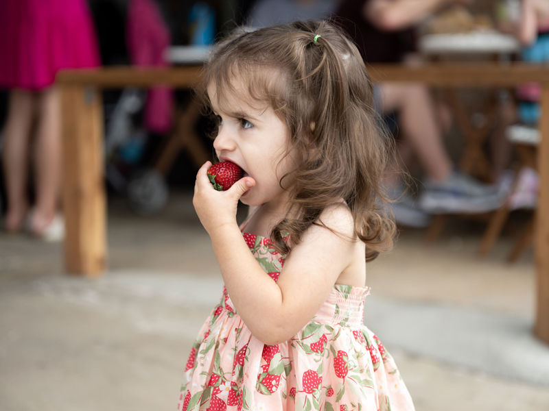 Girl eating strawberry