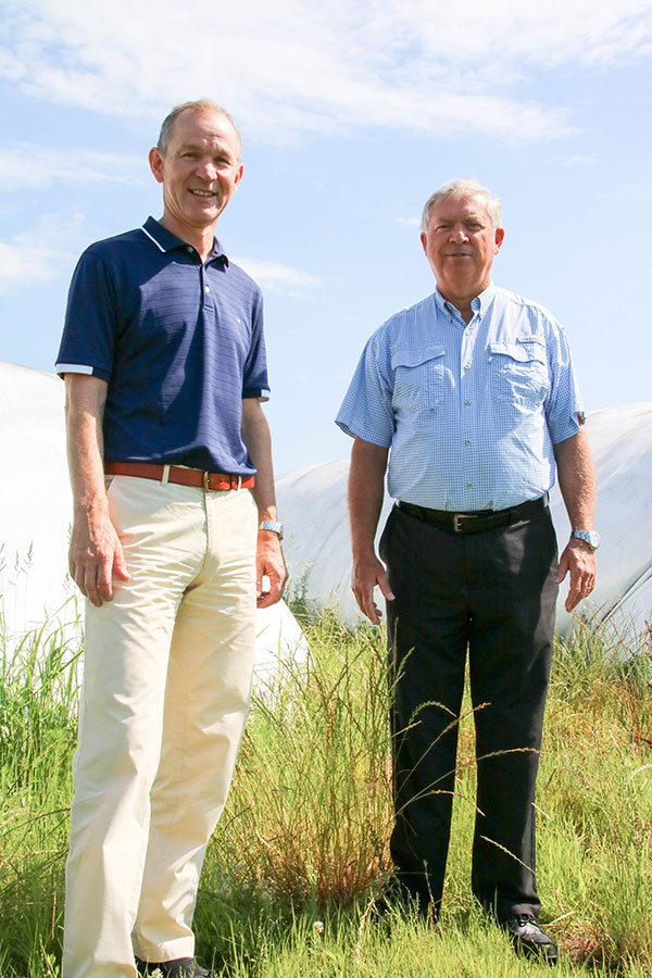 Guus Gerritsen and David Peele in front of bags that store clary sage, LCD photo