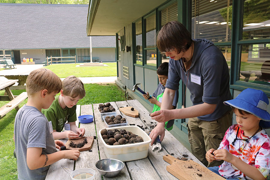 John Sommerville helps young participants crack black walnuts for black walnut and cinnamon ice cream.