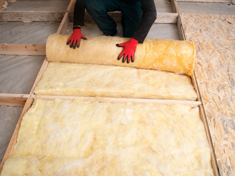 Rolling out attic insulation